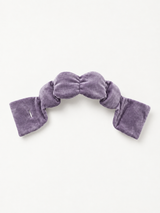 A contoured weighted sleep mask laid flat, one of the best weighted sleep masks for ergonomic eye coverage