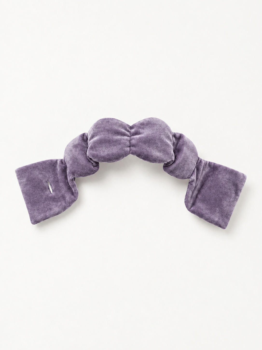A contoured weighted sleep mask laid flat, one of the best weighted sleep masks for ergonomic eye coverage
