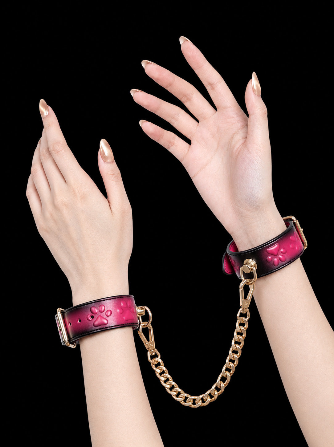 handchain thermochromic leather wrist cuffs with embossed heart paw print pattern heat reactive pink marks polished gold metal hardware worn on both hands solid black background