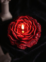 Low Temp Wax Play Candles, red rose candle placed on soft black velvet for elegant dark still life display