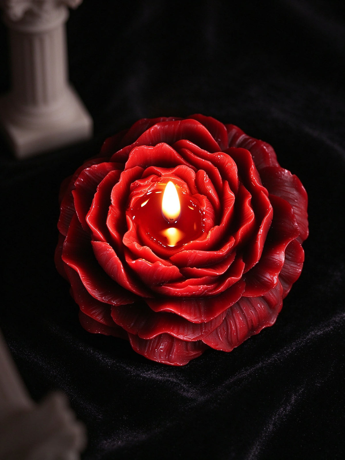 Low Temp Wax Play Candles, red rose candle placed on soft black velvet for elegant dark still life display