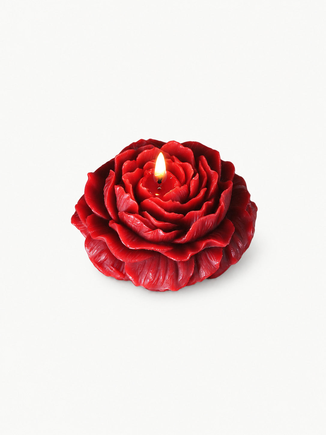 Low Temp Wax Play Candles, red rose shaped floral candle with burning flame, isolated on clean white background