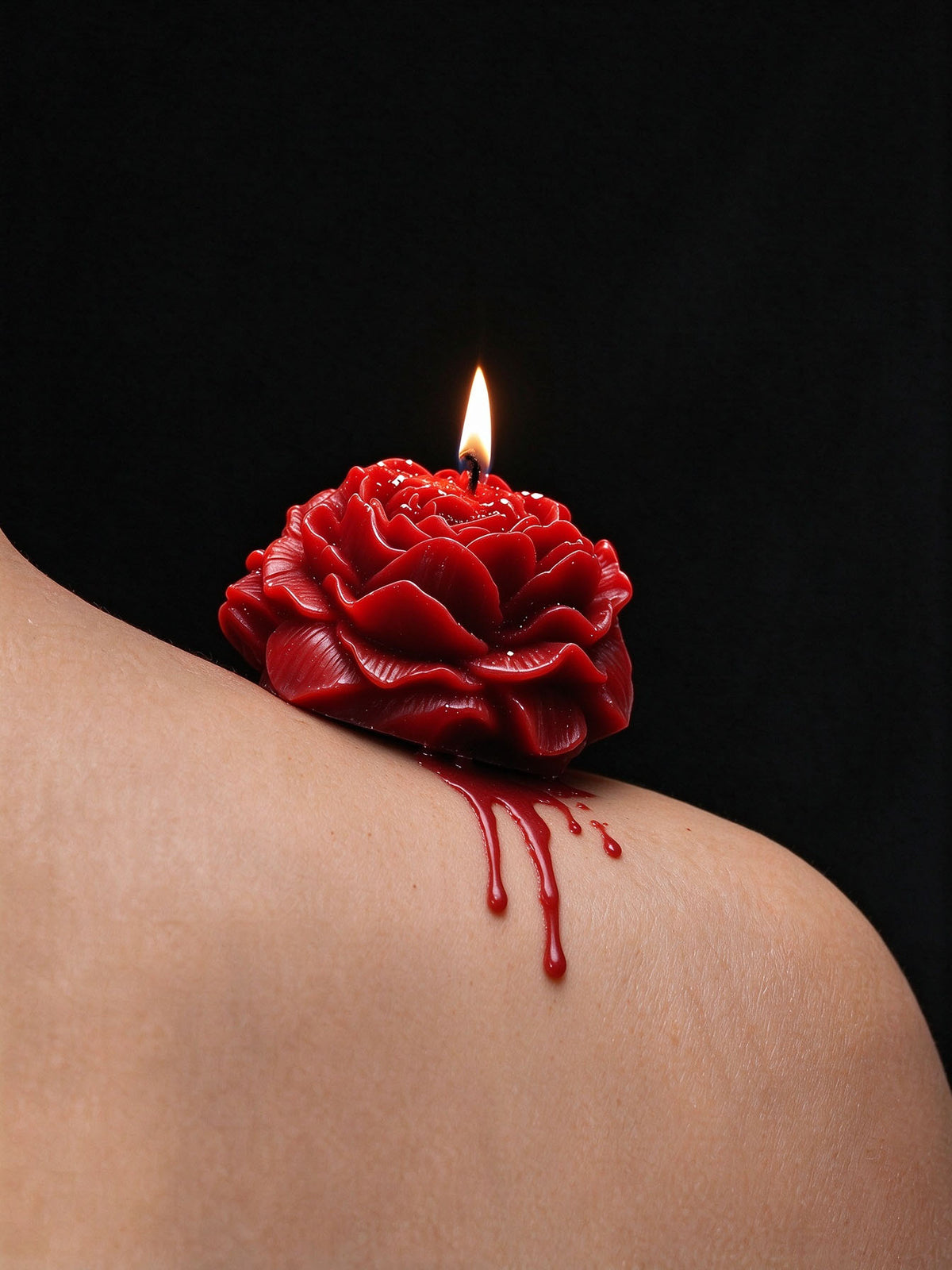 Low Temp Wax Play Candles, red rose candle resting on shoulder with softly dripping melted wax
