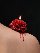 Low Temp Wax Play Candles, red rose candle resting on shoulder with softly dripping melted wax