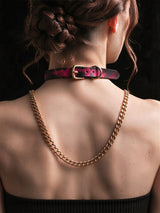 Thermochromic leather choker necklace on model back view, pink black gradient temperature color changing collar with gold adjustable buckle and D ring, thick gold curb chain fashion accessory