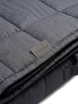 Weighted blanket corner fold showing quilted stitching and Duska brand tag