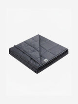 Duska weighted blanket folded, showing quilted grid stitching in charcoal grey