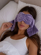 Woman adjusting her weighted eye mask for sleeping, one of the weighted eye masks for sleep built for nightly use